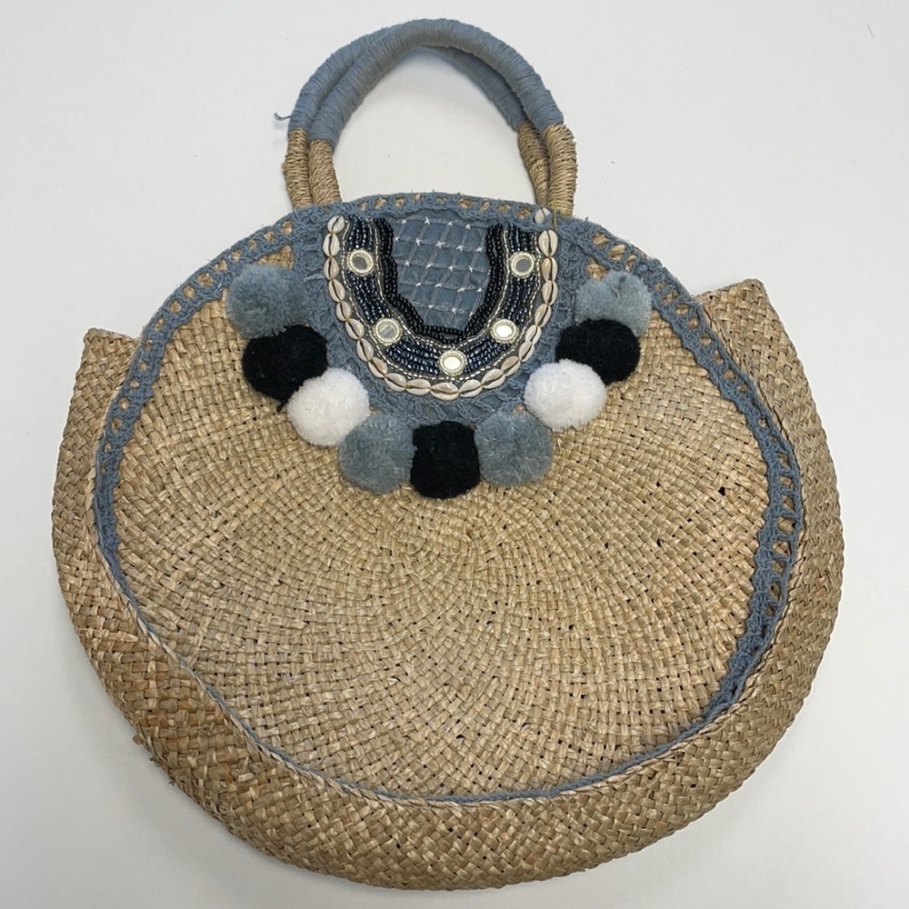 Handmade beaded straw bag with shell and Pom Pom detail